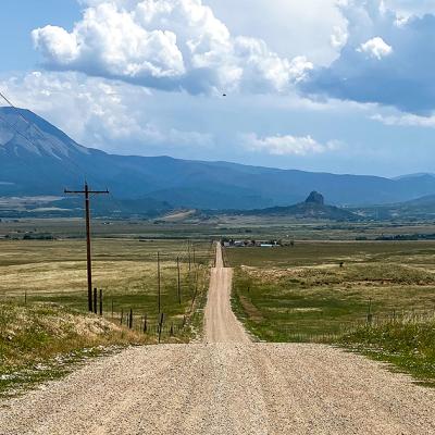 A dirt road heads towards the Spanish Peaks in the Colorado Rocky Mountains