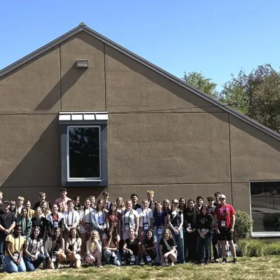 A group shot of Youth Tour delegates standing in front of the CREA headquarters building.